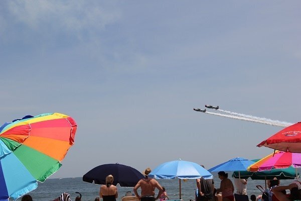 Ocean City Airshow planes flying over the beach creating a jet streams